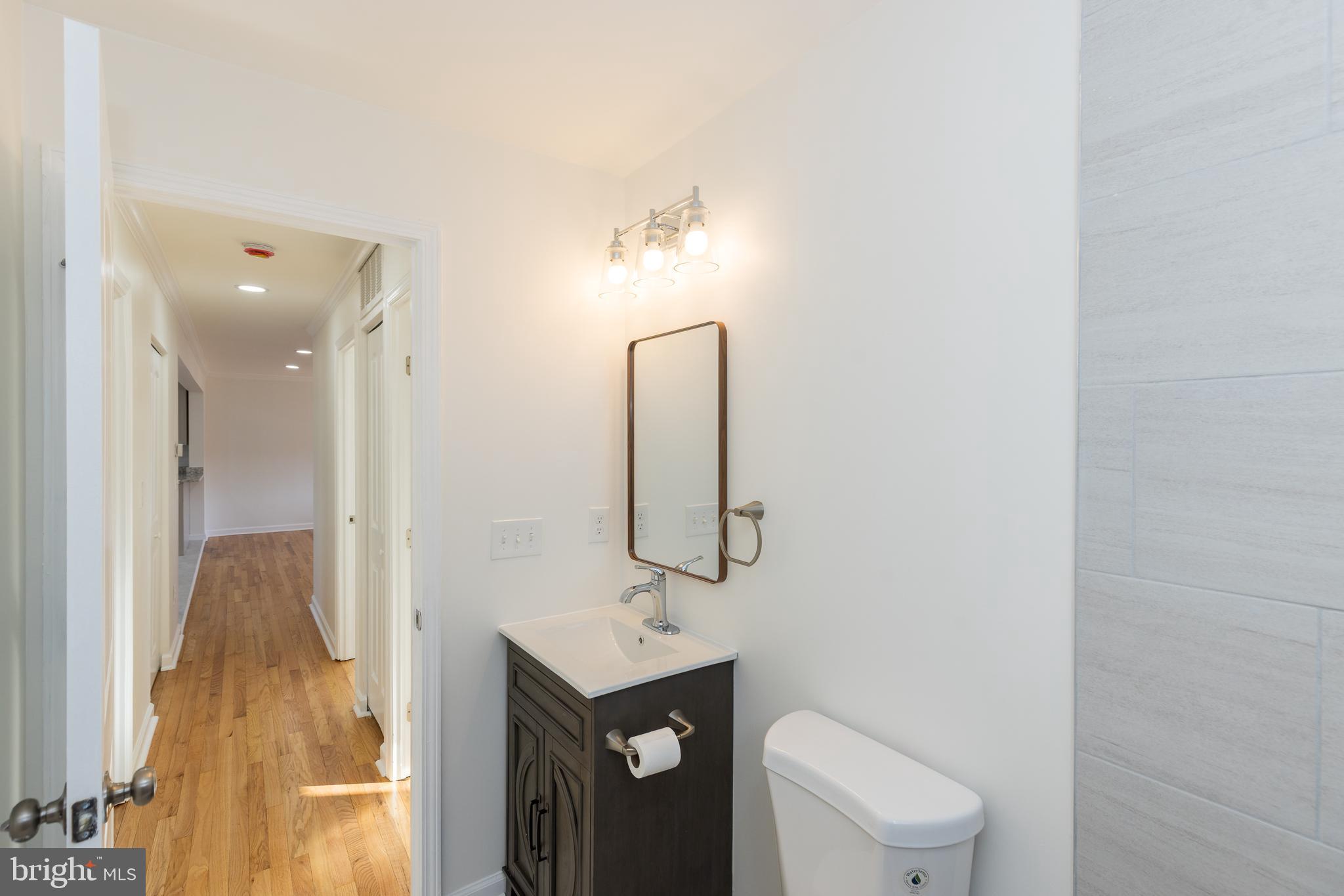 5510 Daybreak Terrace Baltimore, MD 21206 - Photo 25 of 43 a bathroom with a toilet sink and mirror