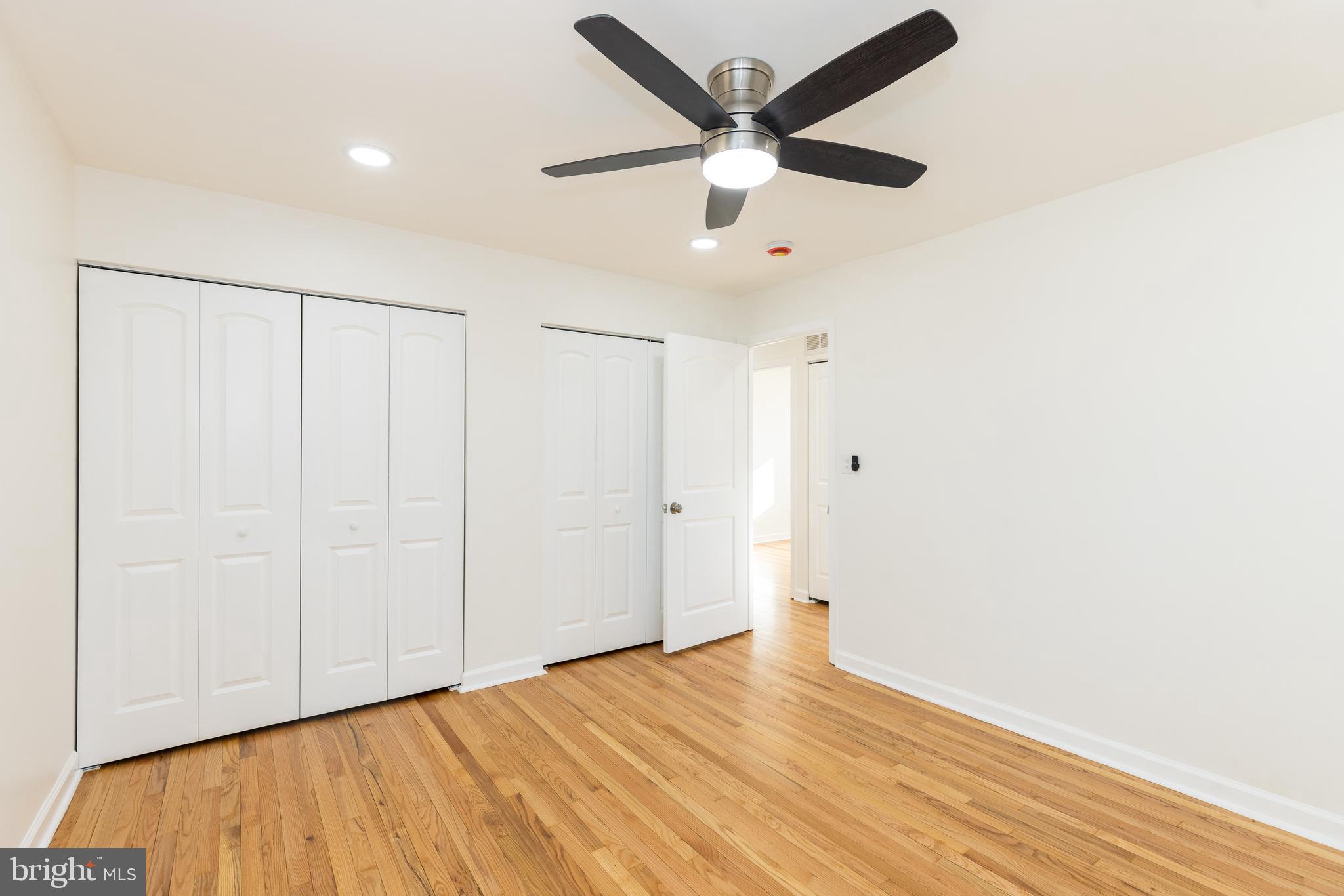 5510 Daybreak Terrace Baltimore, MD 21206 - Photo 28 of 43 an empty room with wooden floor and windows