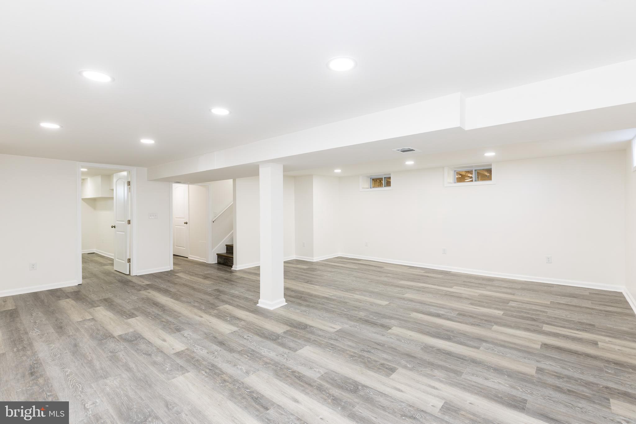 5510 Daybreak Terrace Baltimore, MD 21206 - Photo 32 of 43 an empty room with wooden floor and windows