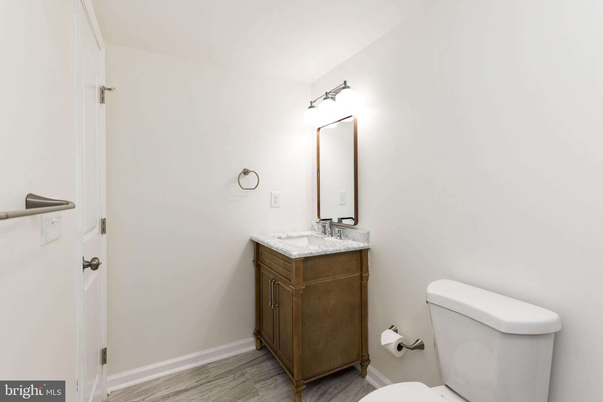 5510 Daybreak Terrace Baltimore, MD 21206 - Photo 38 of 43 a bathroom with a toilet sink and mirror