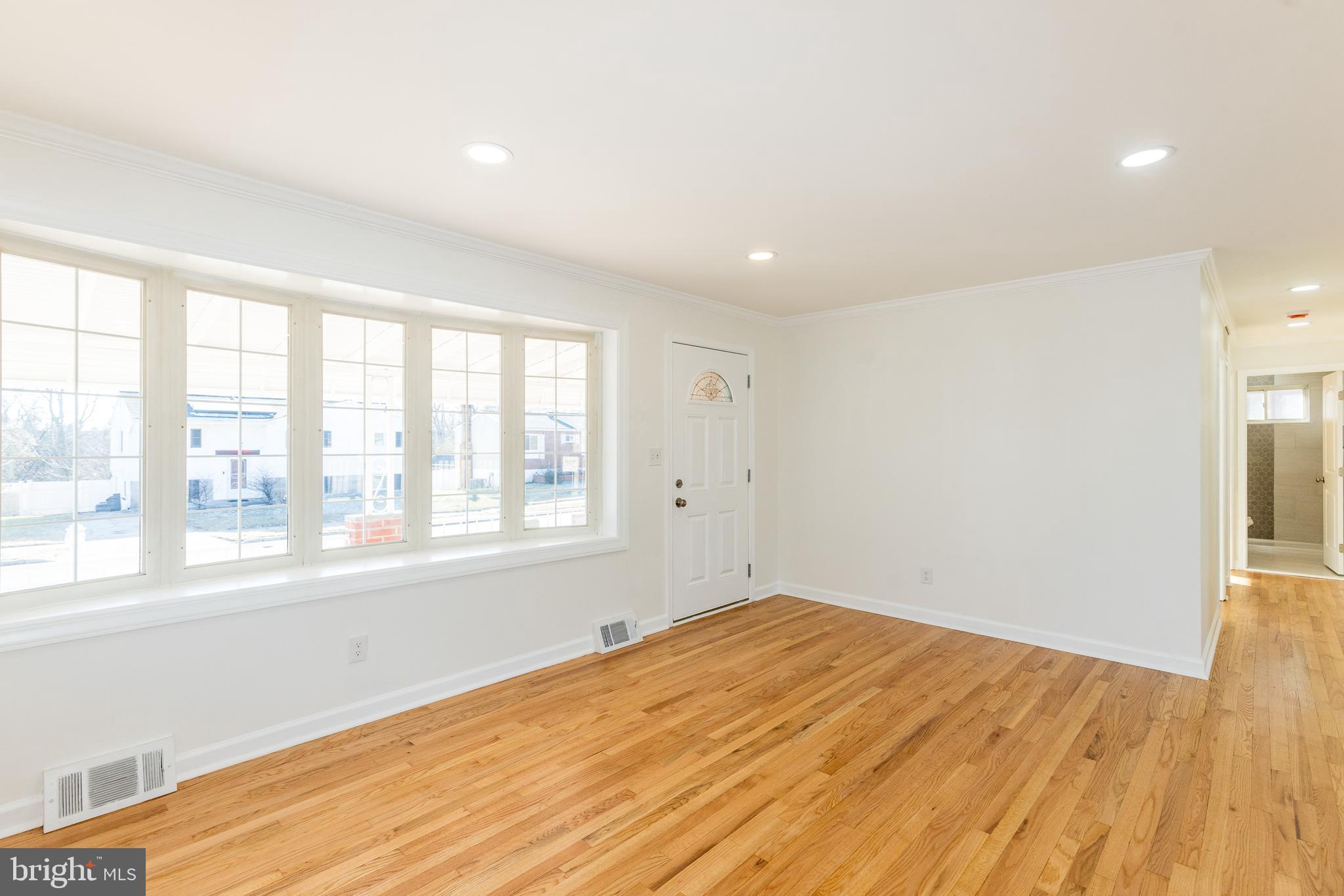 5510 Daybreak Terrace Baltimore, MD 21206 - Photo 5 of 43 a view of empty room with wooden floor and fan