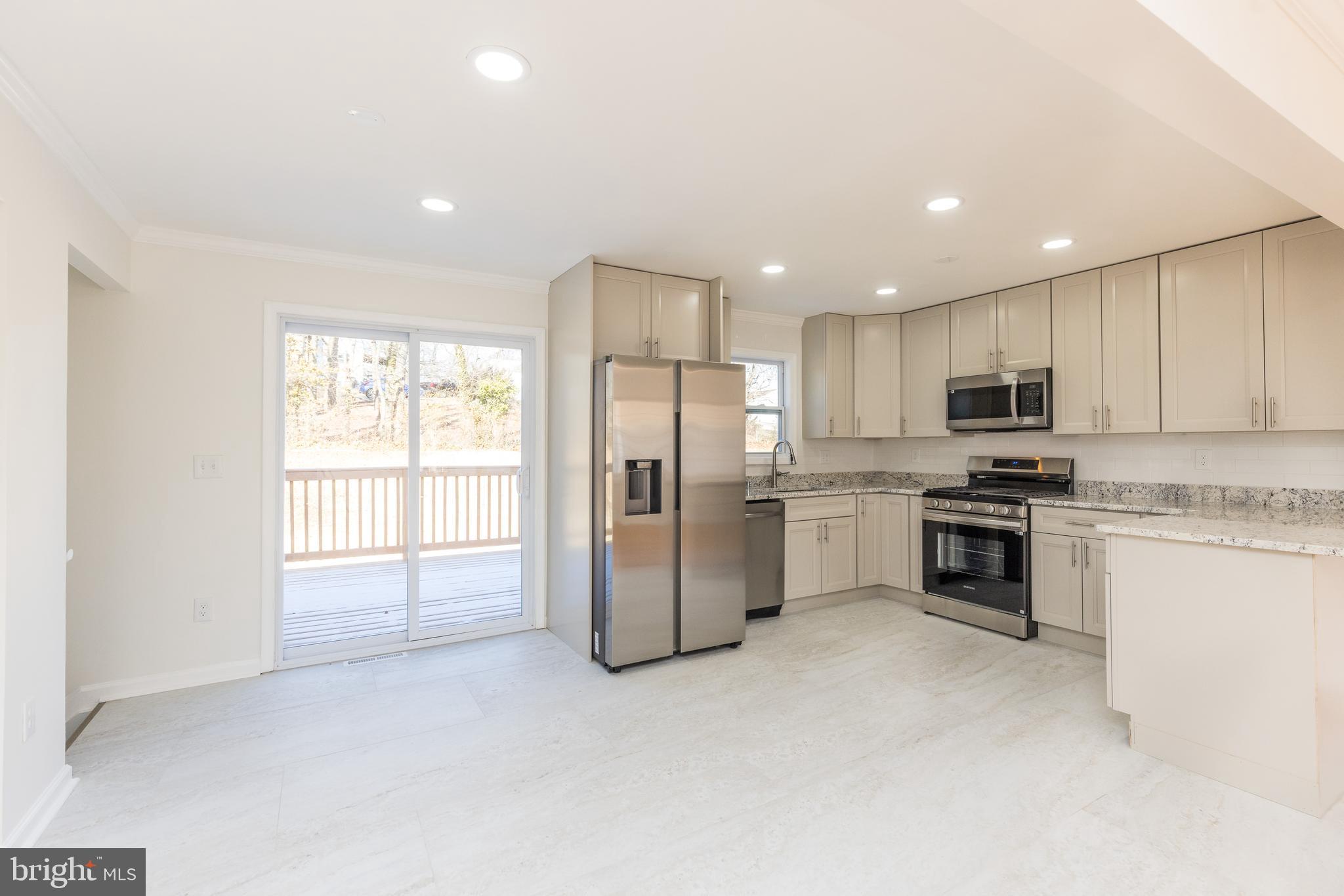 5510 Daybreak Terrace Baltimore, MD 21206 - Photo 7 of 43 a kitchen with granite countertop white cabinets and stainless steel appliances