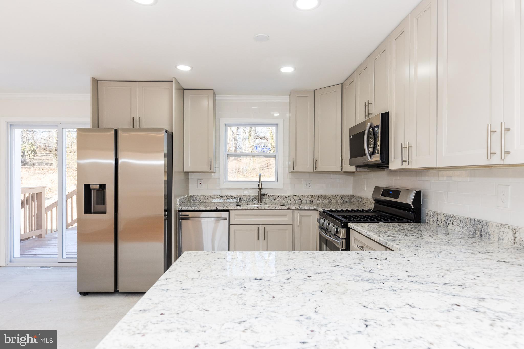 5510 Daybreak Terrace Baltimore, MD 21206 - Photo 10 of 43 a kitchen with stainless steel appliances granite countertop a refrigerator stove microwave and sink