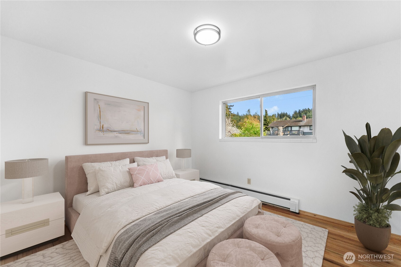3501 West 3rd Street Anacortes, WA 98221 - Photo 11 of 28 a bedroom with a bed and a potted plant