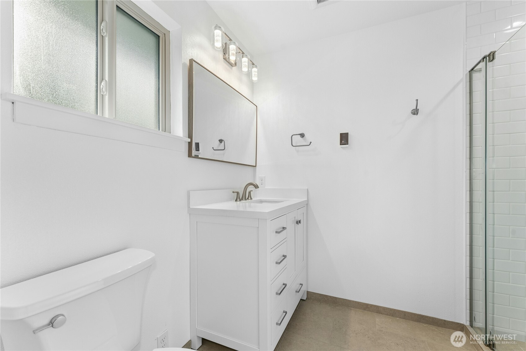 3501 West 3rd Street Anacortes, WA 98221 - Photo 13 of 28 a bathroom with a sink a toilet and mirror