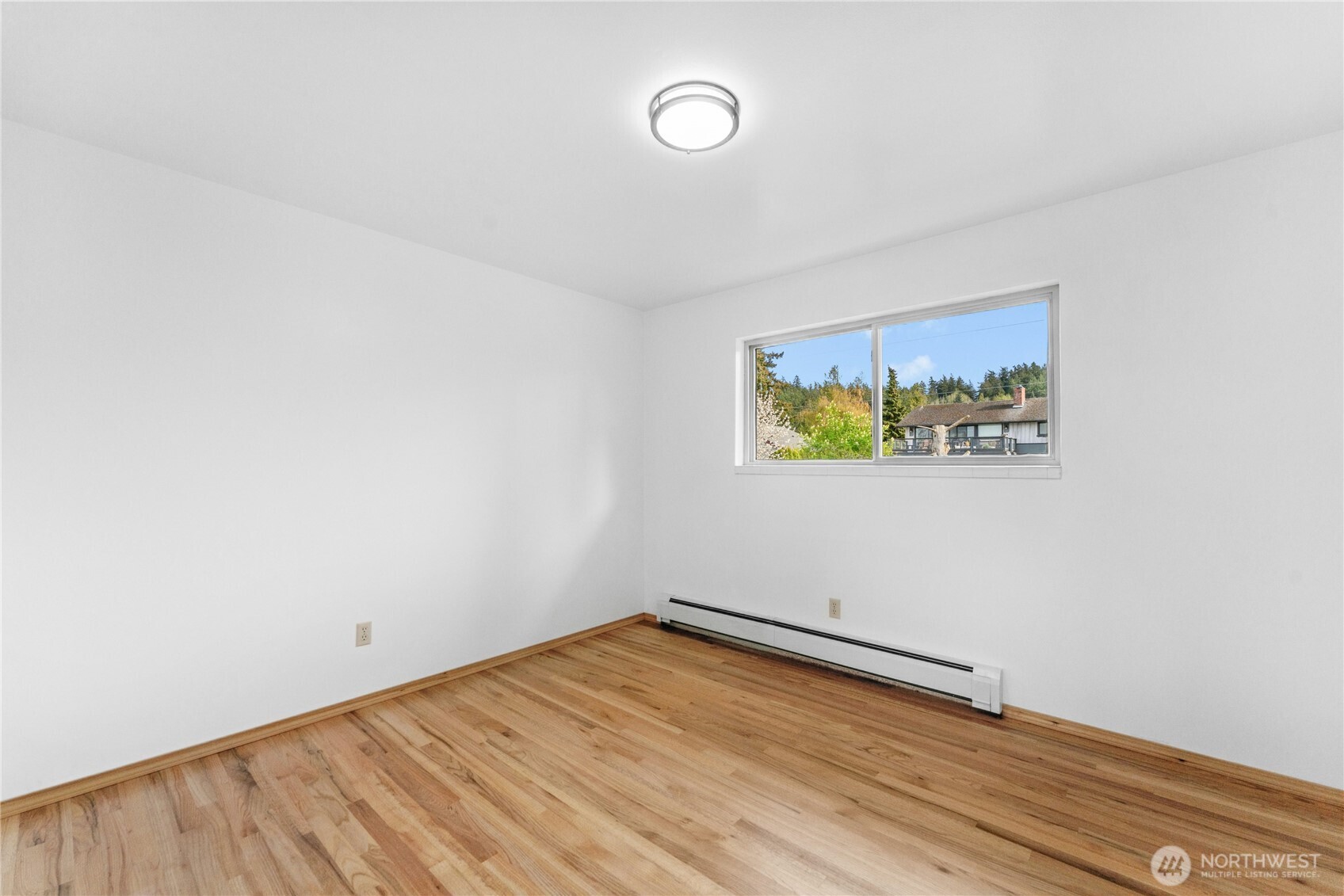 3501 West 3rd Street Anacortes, WA 98221 - Photo 15 of 28 a view of a room with wooden floor and window