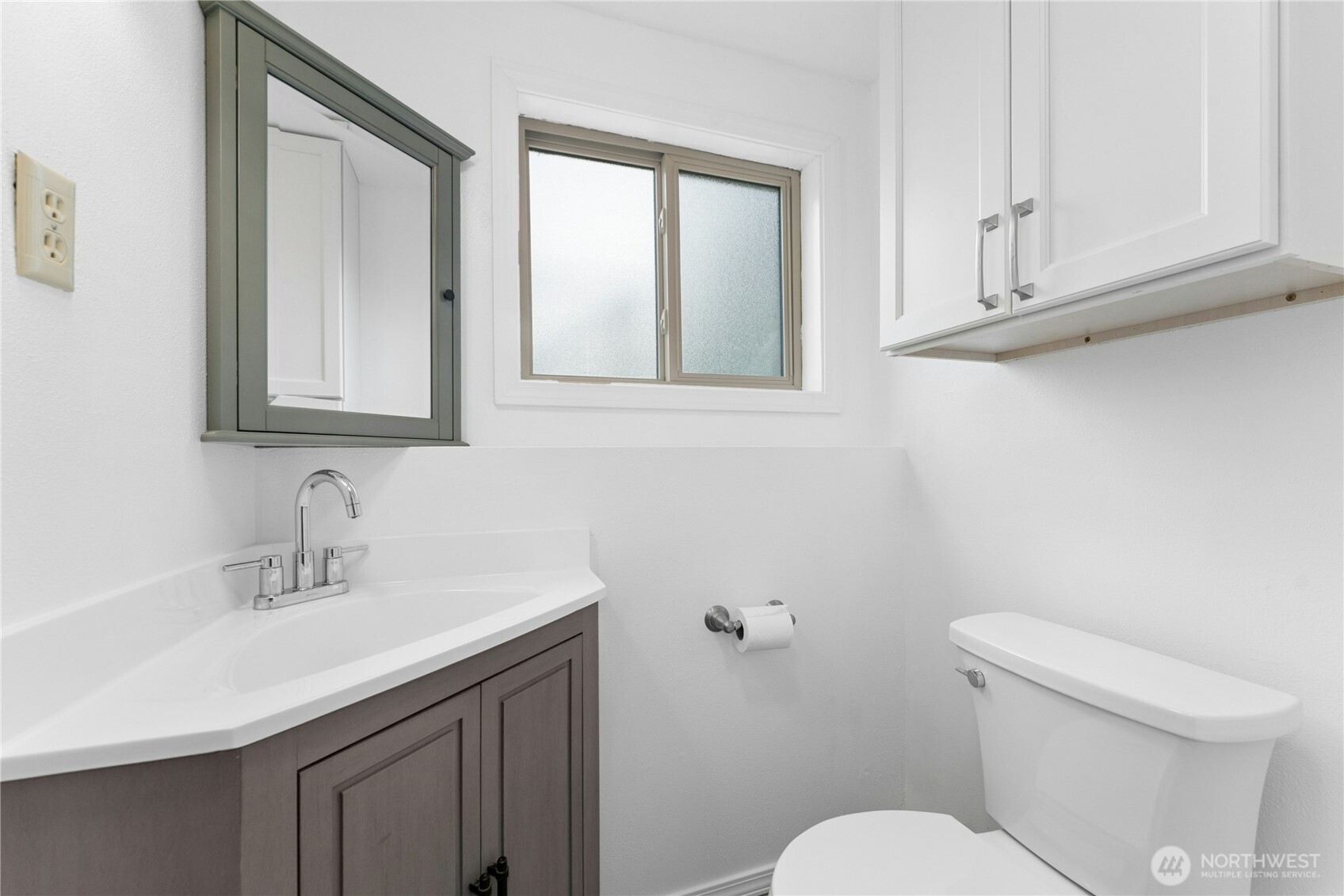 3501 West 3rd Street Anacortes, WA 98221 - Photo 22 of 28 a bathroom with a toilet sink and mirror