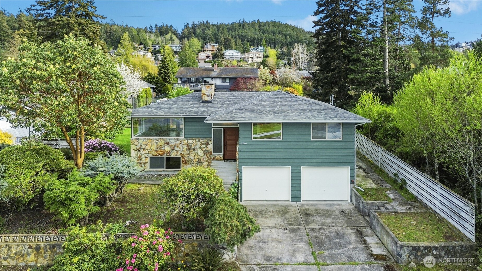 3501 West 3rd Street Anacortes, WA 98221 - Photo 26 of 28 a front view of house with yard and trees in the background