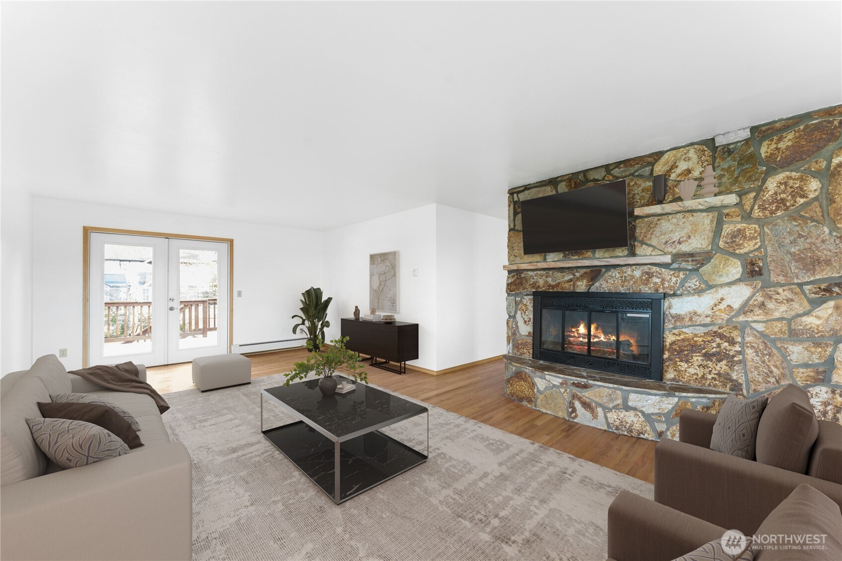 3501 West 3rd Street Anacortes, WA 98221 - Photo 5 of 28 a living room with furniture a flat screen tv and a fireplace