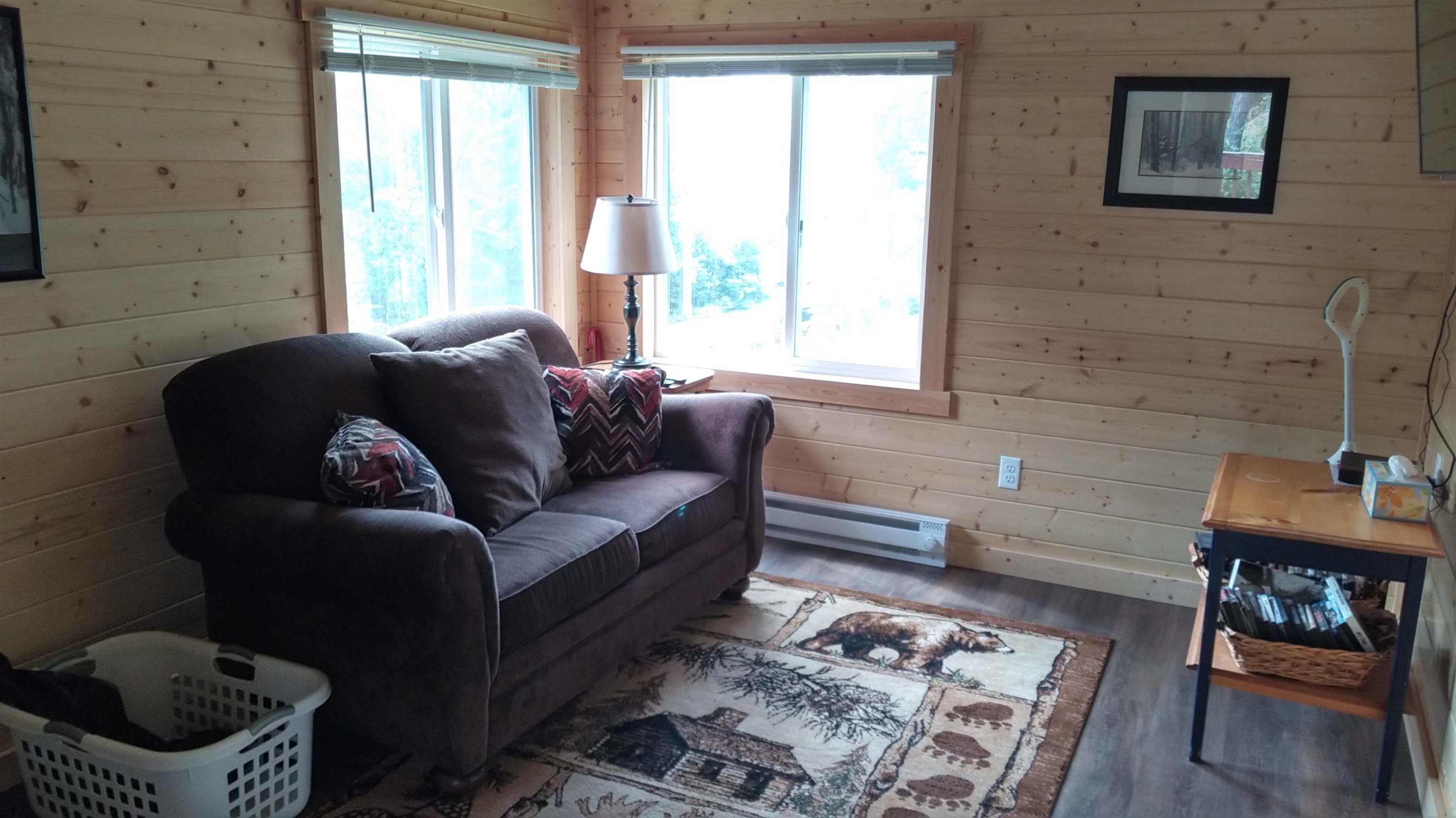 13496 Pine Road, Unit 10 Ely, MN 55731 - Photo 15 of 26 Living room with wooden walls, wood finished floors, and baseboard heating