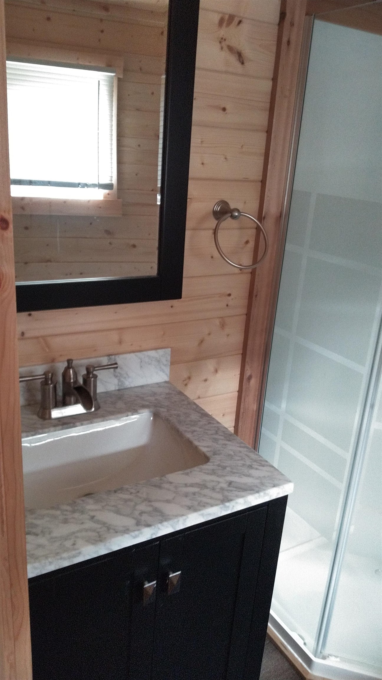13496 Pine Road, Unit 10 Ely, MN 55731 - Photo 17 of 26 Bathroom featuring wooden walls and vanity