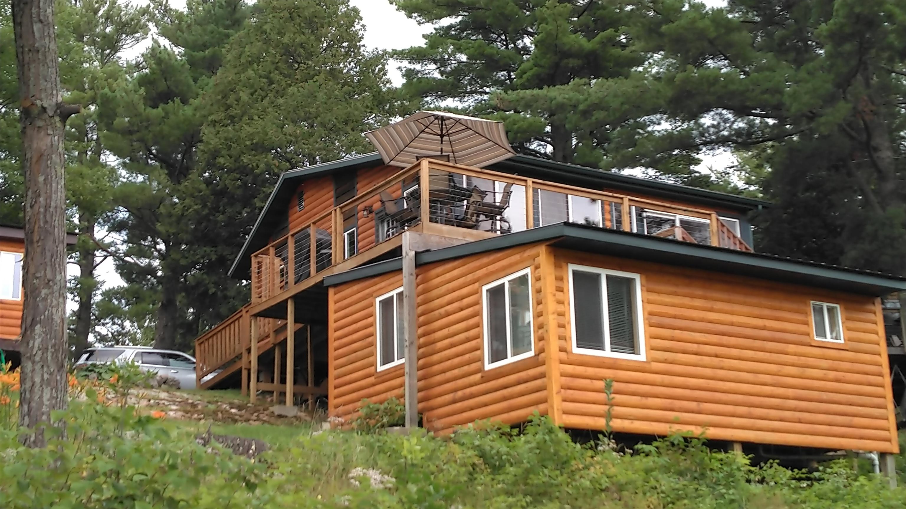13496 Pine Road, Unit 10 Ely, MN 55731 - Photo 2 of 26 View of side of home featuring log veneer siding and a deck