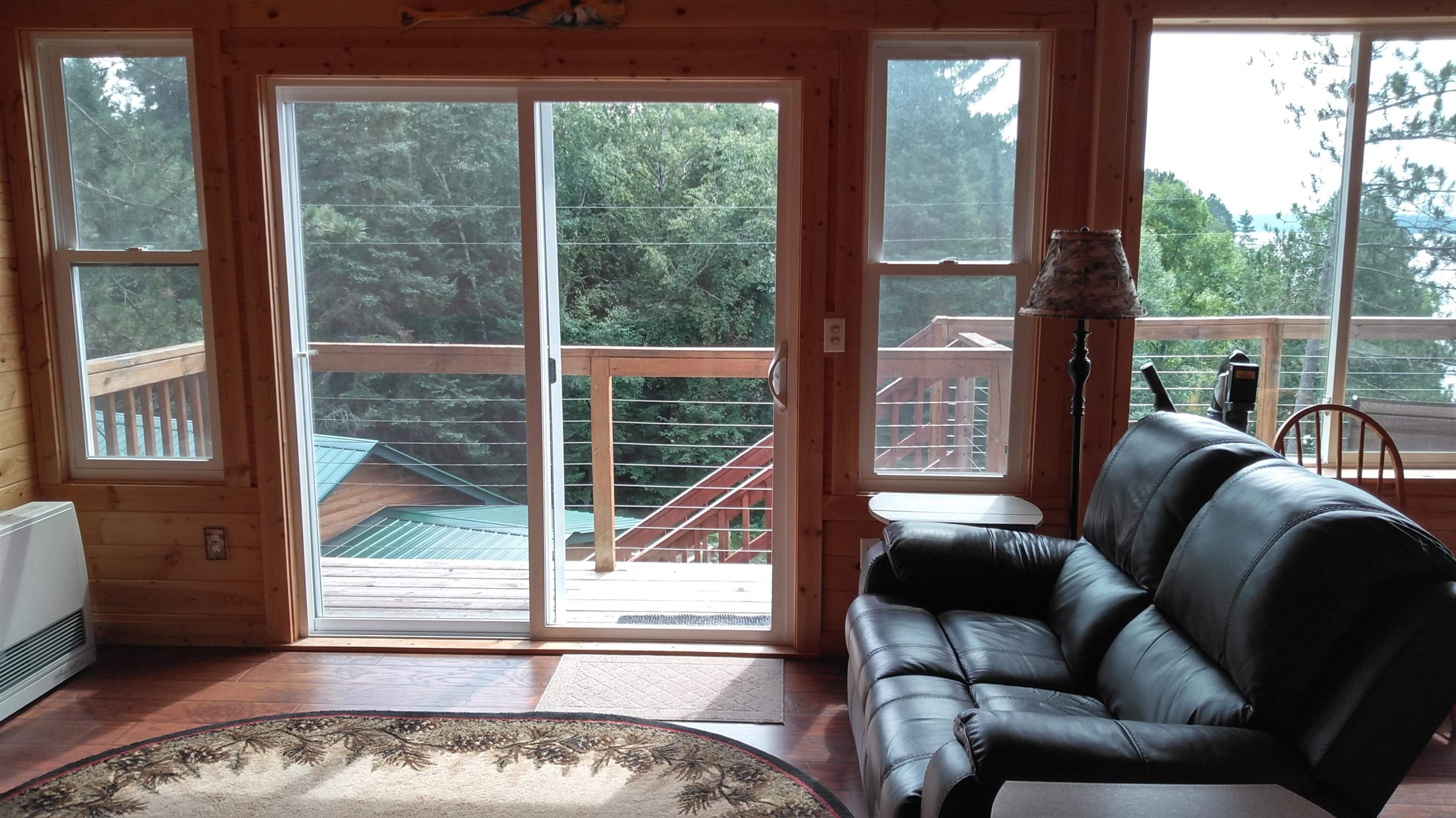 13496 Pine Road, Unit 10 Ely, MN 55731 - Photo 5 of 26 Doorway to outside featuring plenty of natural light, wood finished floors, and heating unit