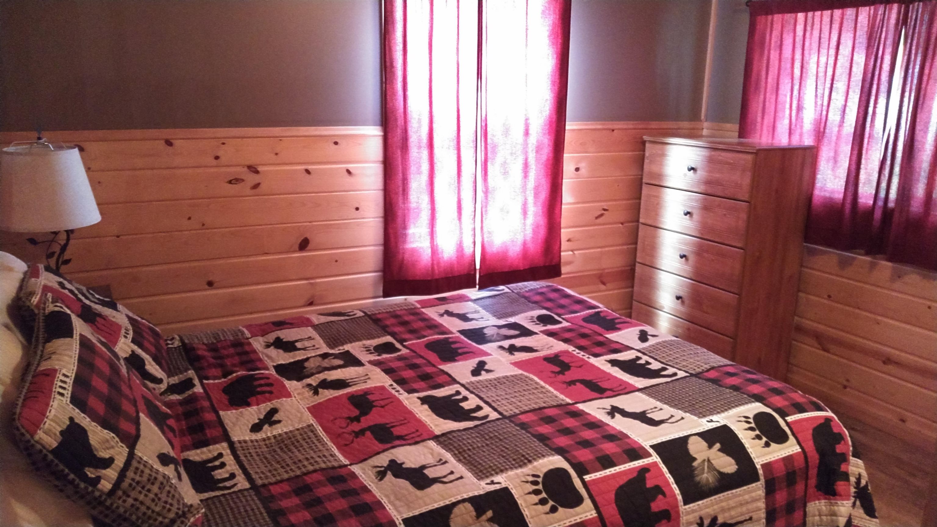 13496 Pine Road, Unit 10 Ely, MN 55731 - Photo 9 of 26 Bedroom with wooden walls, wainscoting, and multiple windows