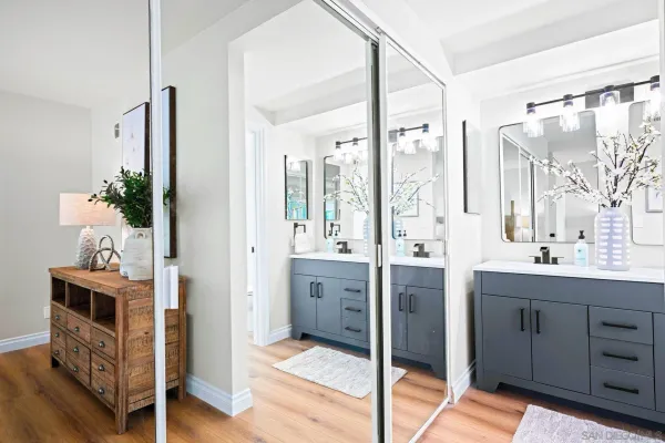 a bathroom with a double vanity sink mirror and shower