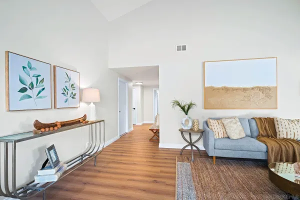 a living room with furniture and a wooden floor