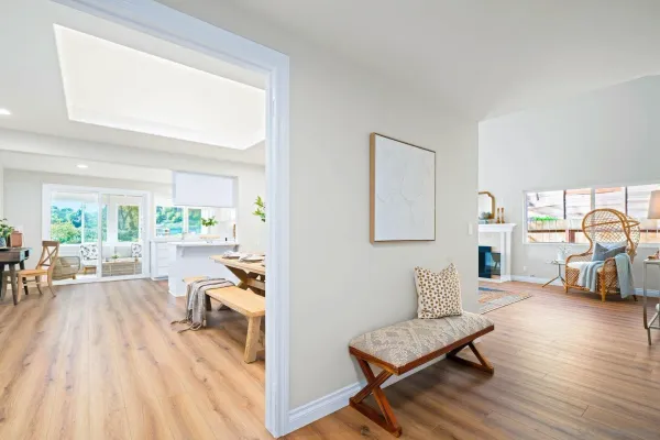 a living room with furniture and a wooden floor