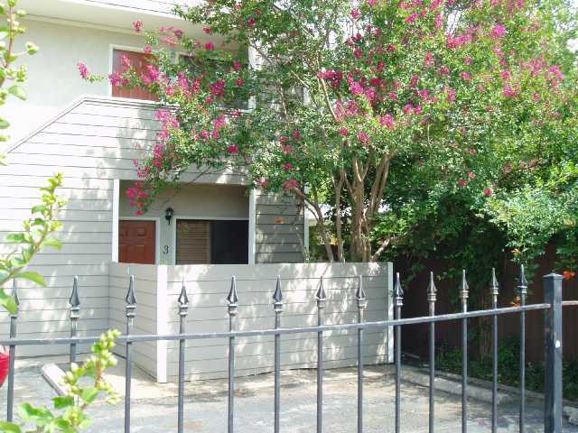 a front view of a house with a tree