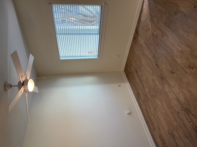 4409 Guadalupe Street, Unit 3 Austin, TX 78751 - Photo 5 of 18 an empty room with wooden floor fan and windows