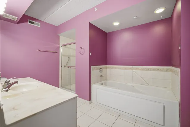 a bathroom with a bathtub sink and a mirror