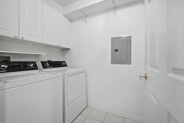 a kitchen with white cabinets and white appliances