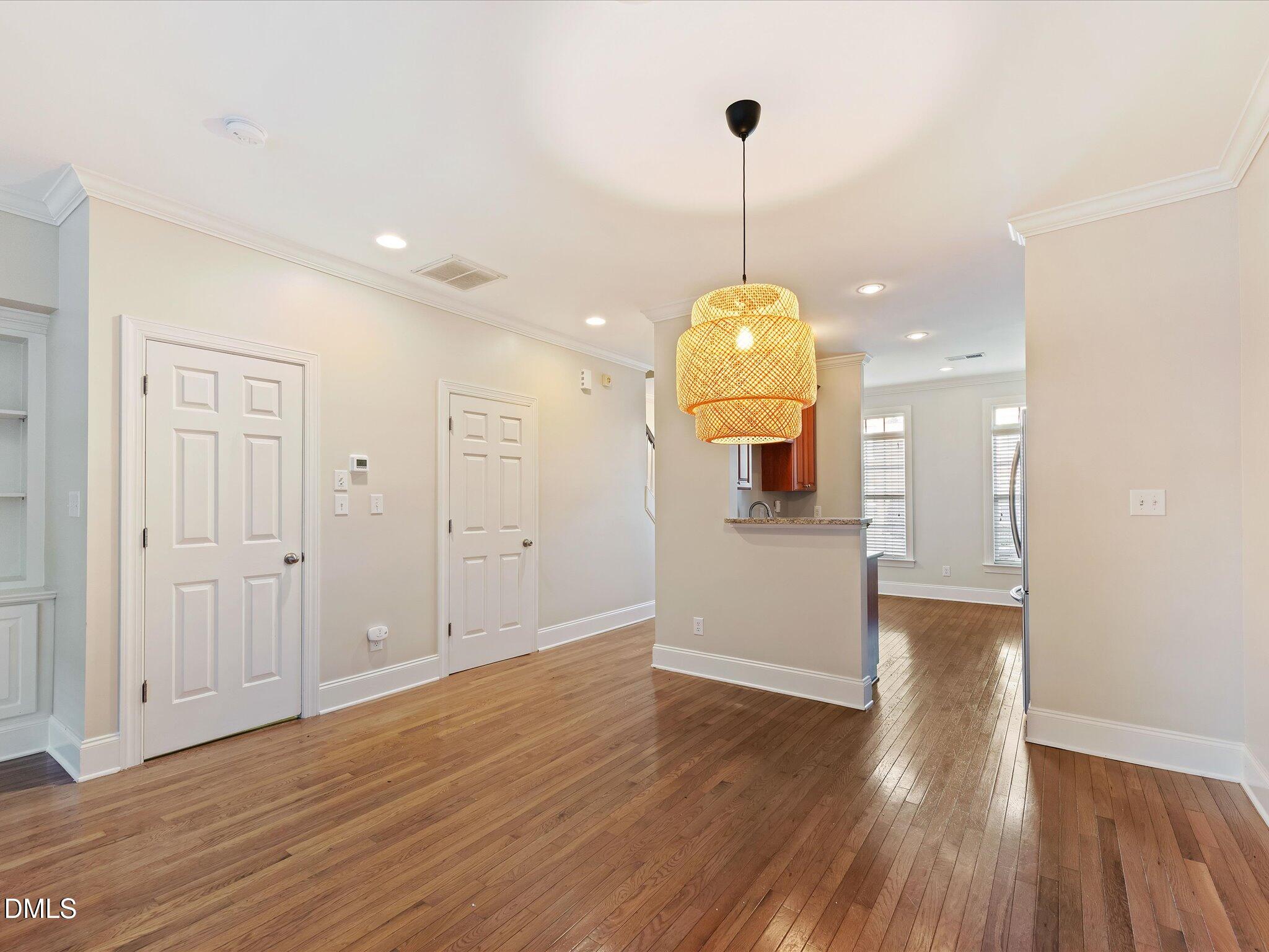606 Highpark Lane Raleigh, NC 27608 - Photo 13 of 27 a view of a room with wooden floor kitchen and windows