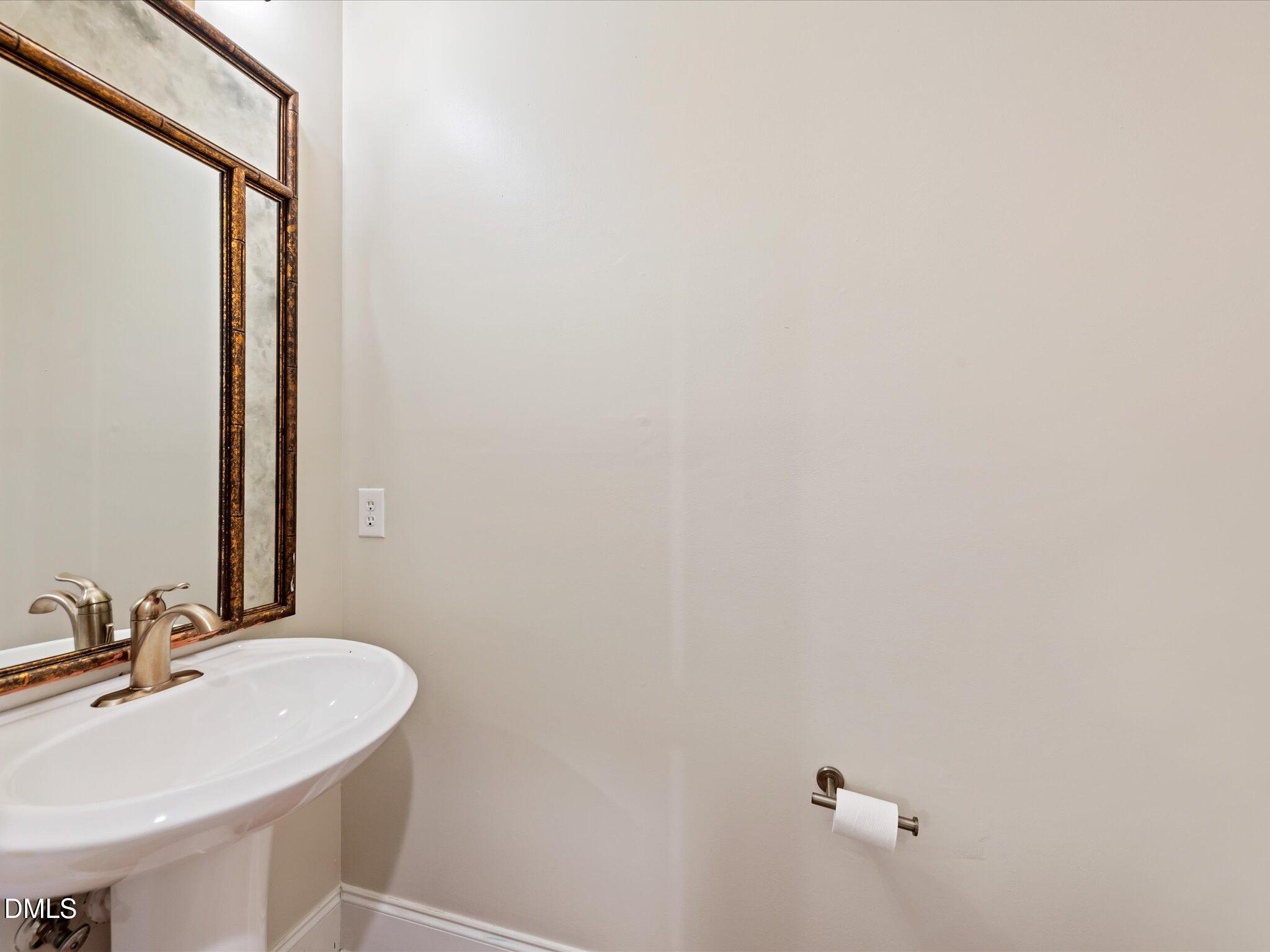 606 Highpark Lane Raleigh, NC 27608 - Photo 14 of 27 a bathroom with a sink and a mirror