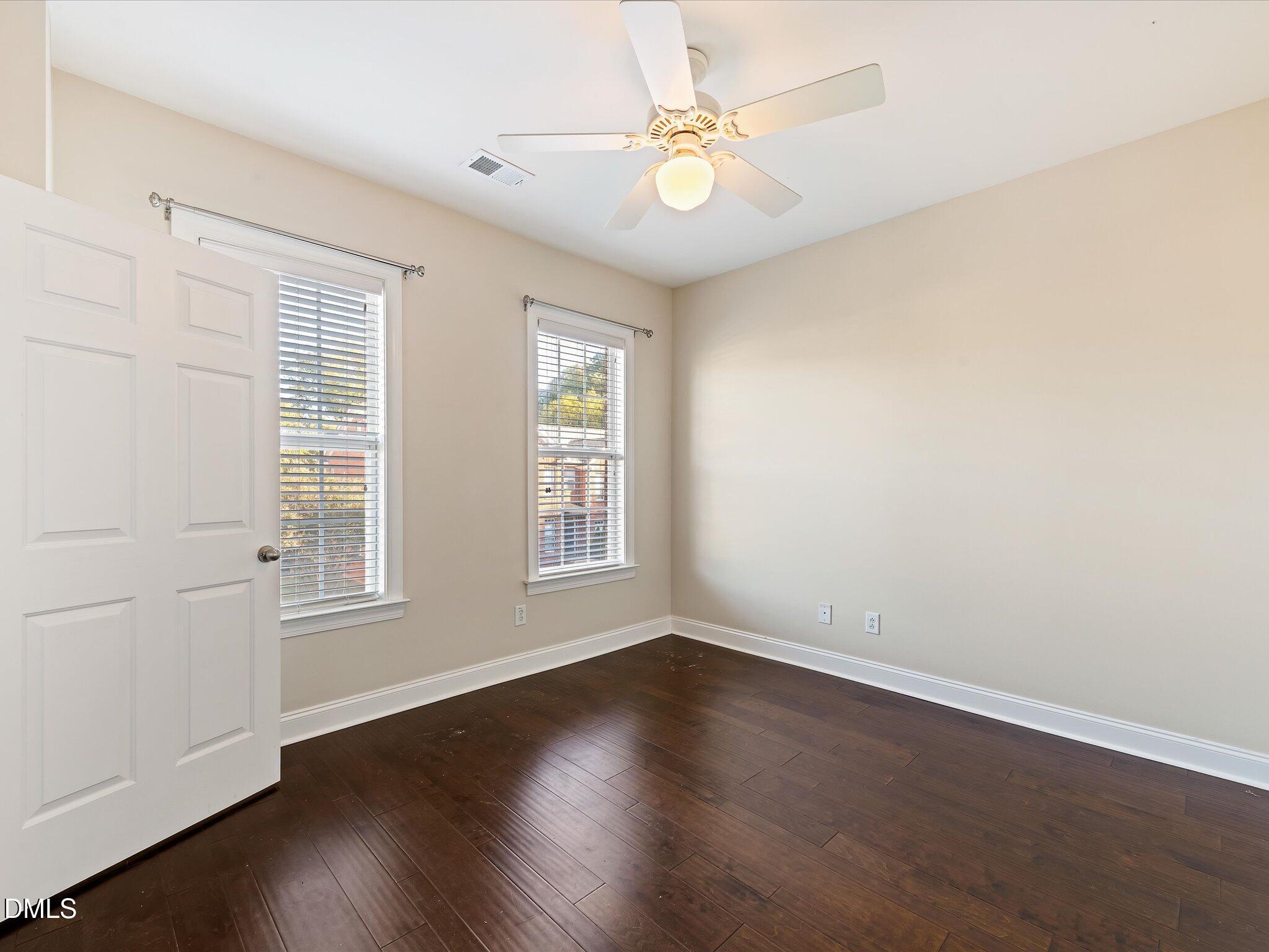 606 Highpark Lane Raleigh, NC 27608 - Photo 15 of 27 an empty room with wooden floor and window