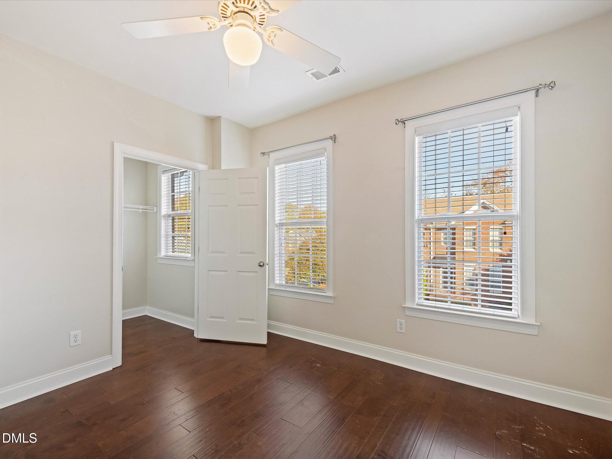 606 Highpark Lane Raleigh, NC 27608 - Photo 16 of 27 a view of an empty room with wooden floor and a window