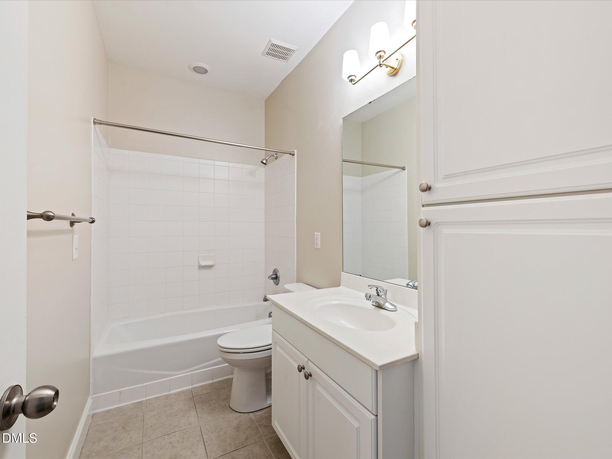 606 Highpark Lane Raleigh, NC 27608 - Photo 18 of 27 a bathroom with a sink a toilet and shower