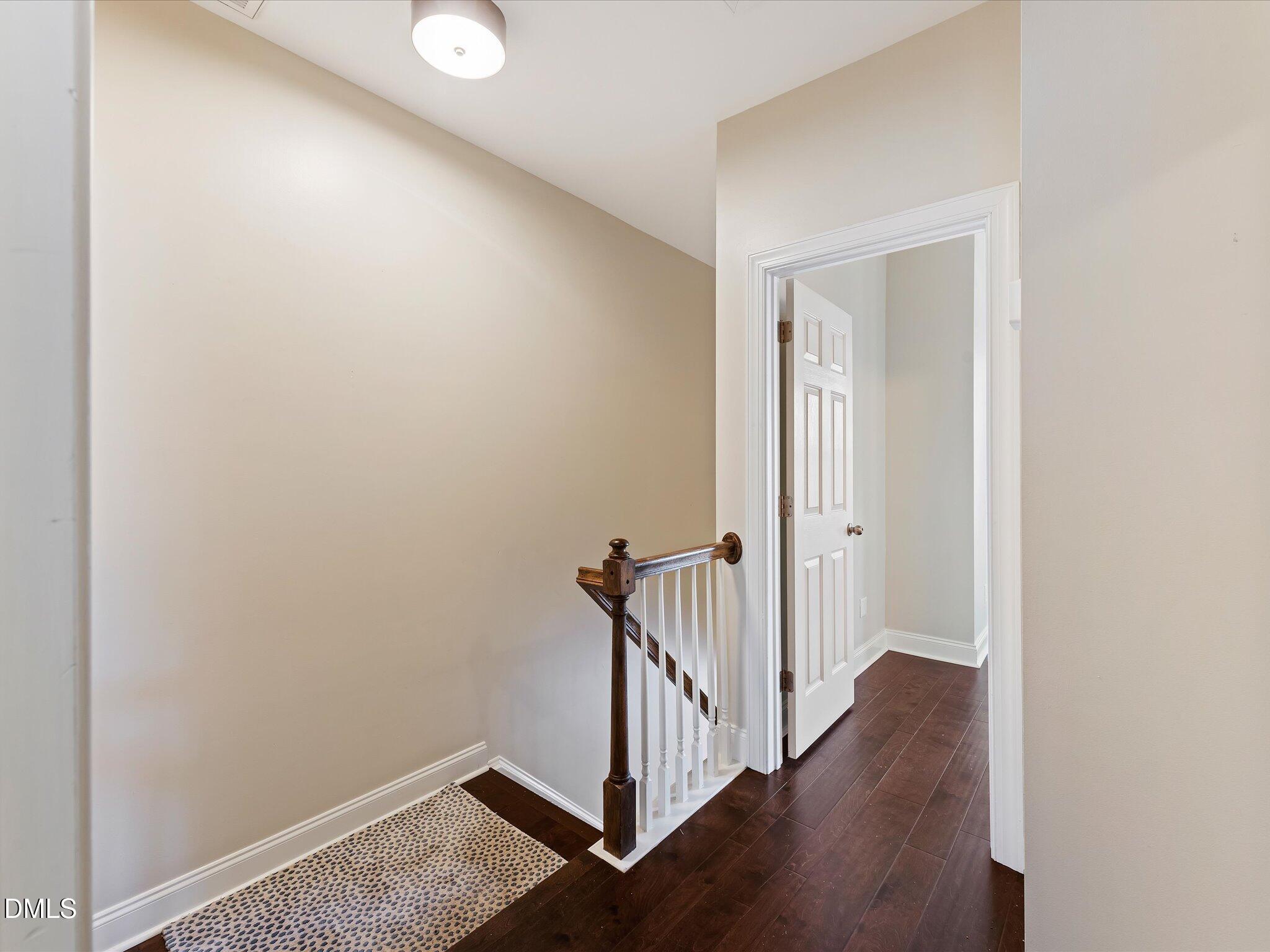 606 Highpark Lane Raleigh, NC 27608 - Photo 20 of 27 a view of a hallway with wooden floor and staircase