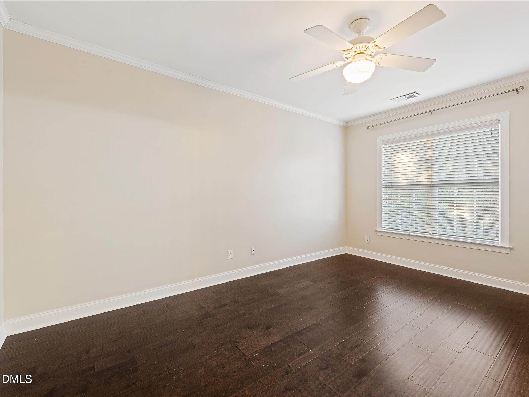 606 Highpark Lane Raleigh, NC 27608 - Photo 22 of 27 an empty room with wooden floor fan and windows