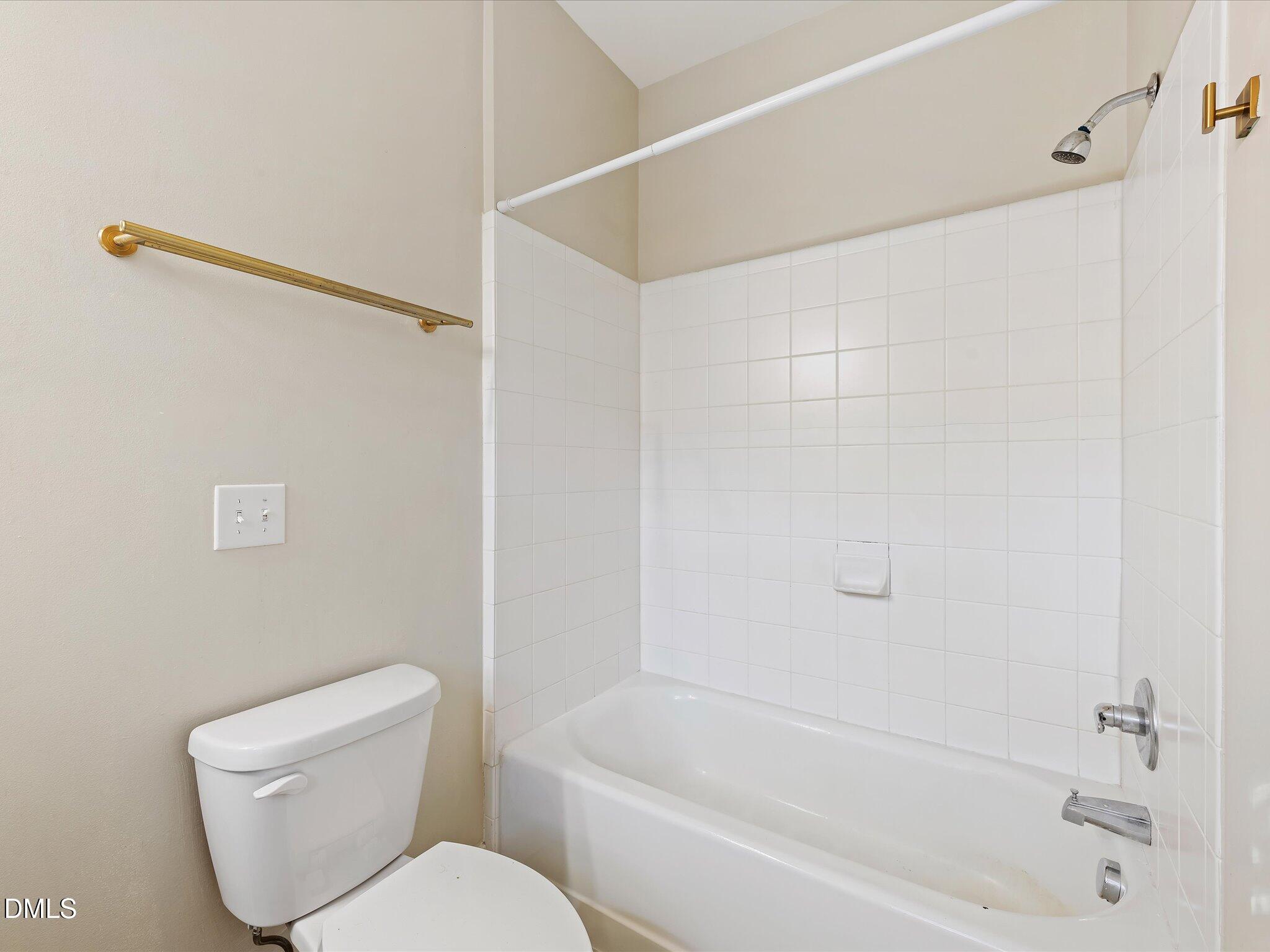 606 Highpark Lane Raleigh, NC 27608 - Photo 24 of 27 a white toilet sitting next to a bath tub