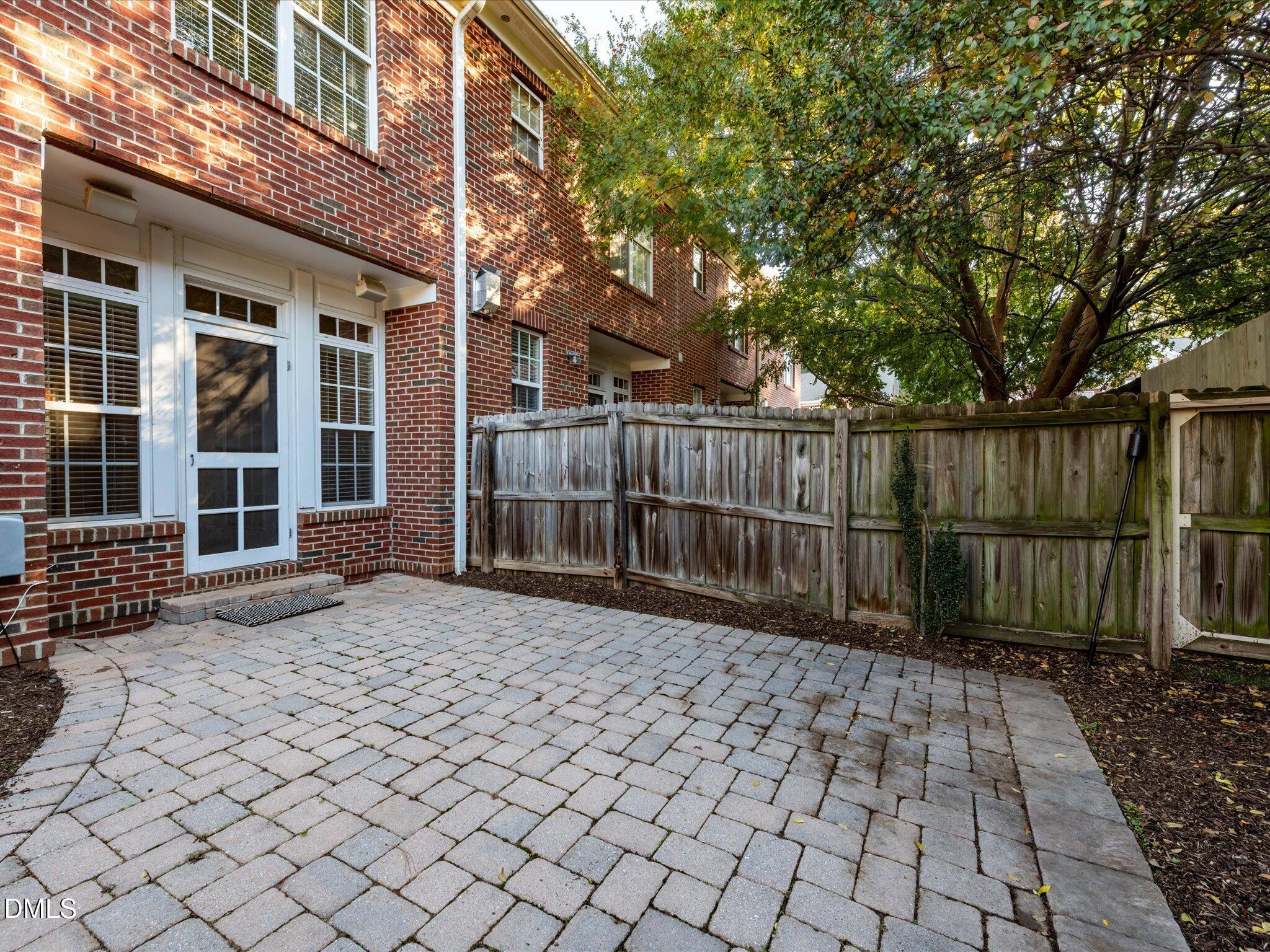 606 Highpark Lane Raleigh, NC 27608 - Photo 25 of 27 a view of a house with a large window and wooden fence