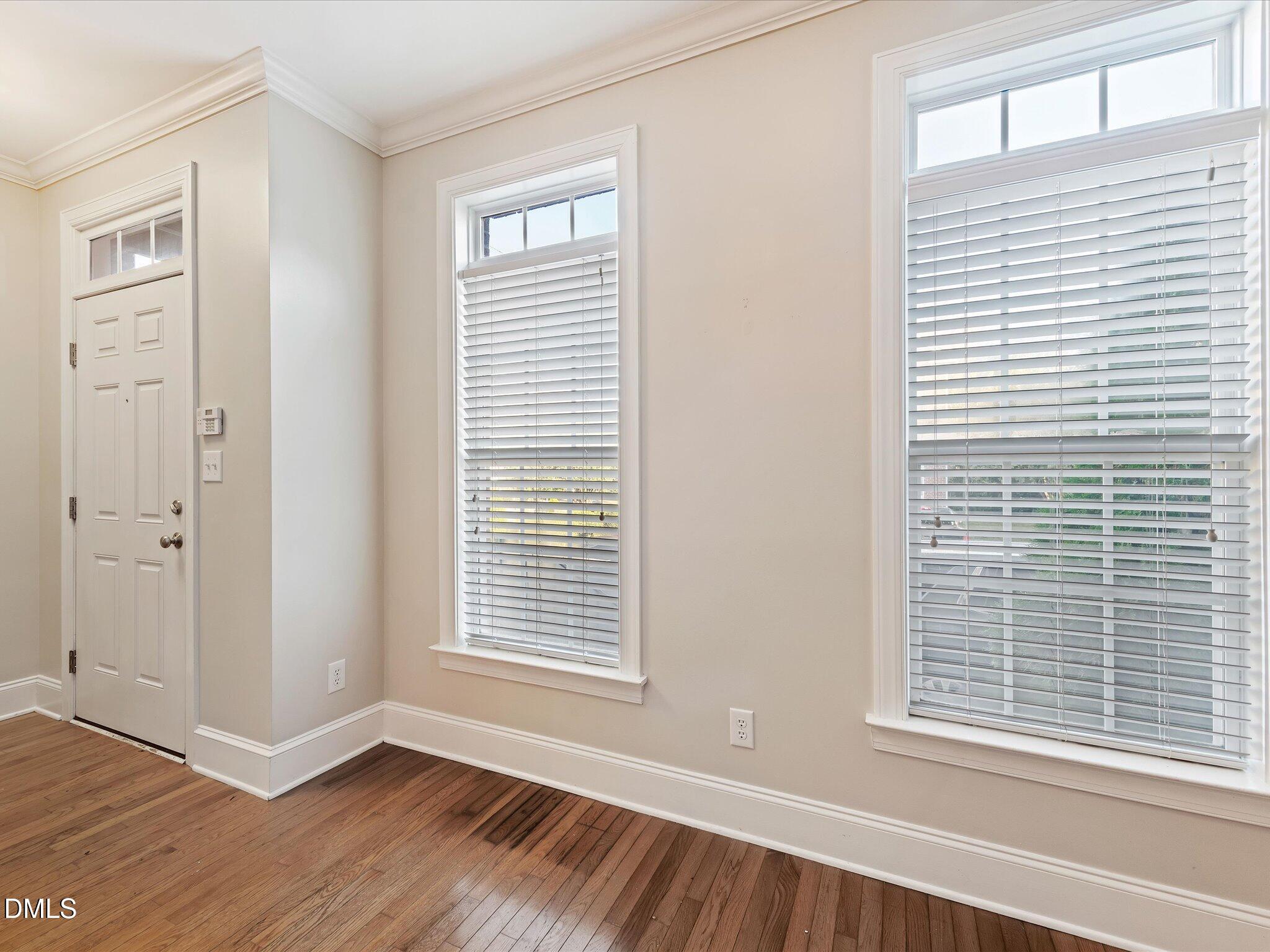 606 Highpark Lane Raleigh, NC 27608 - Photo 6 of 27 a view of an empty room with wooden floor and a window