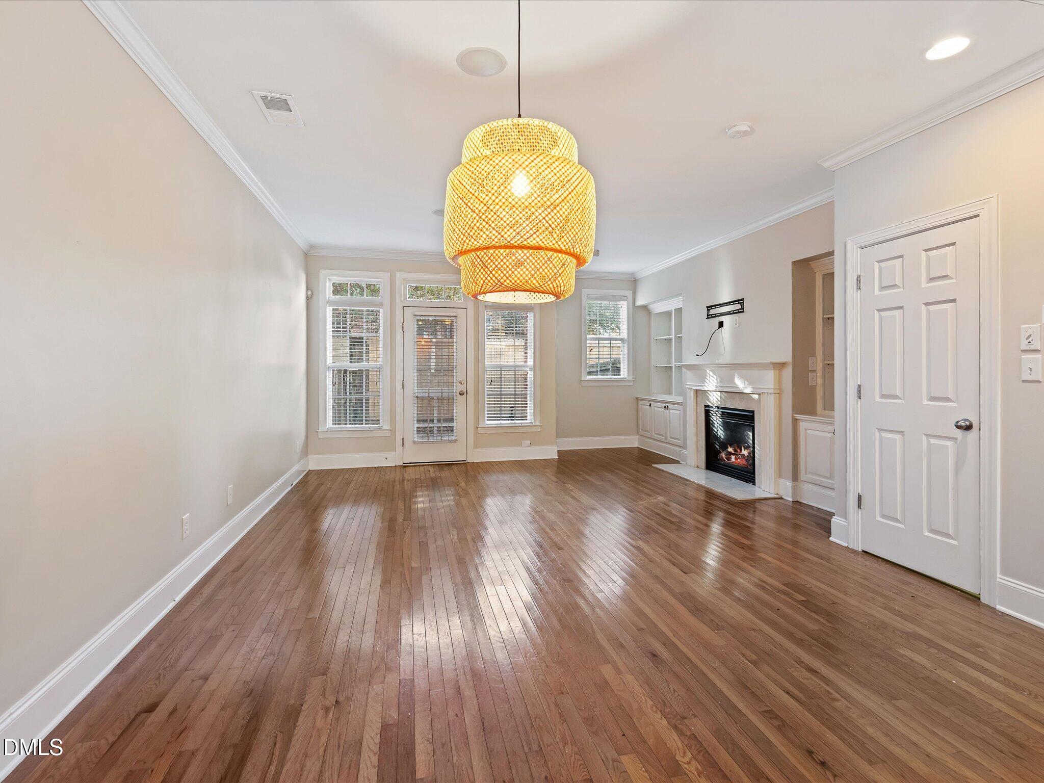 606 Highpark Lane Raleigh, NC 27608 - Photo 9 of 27 a view of empty room with wooden floor and window