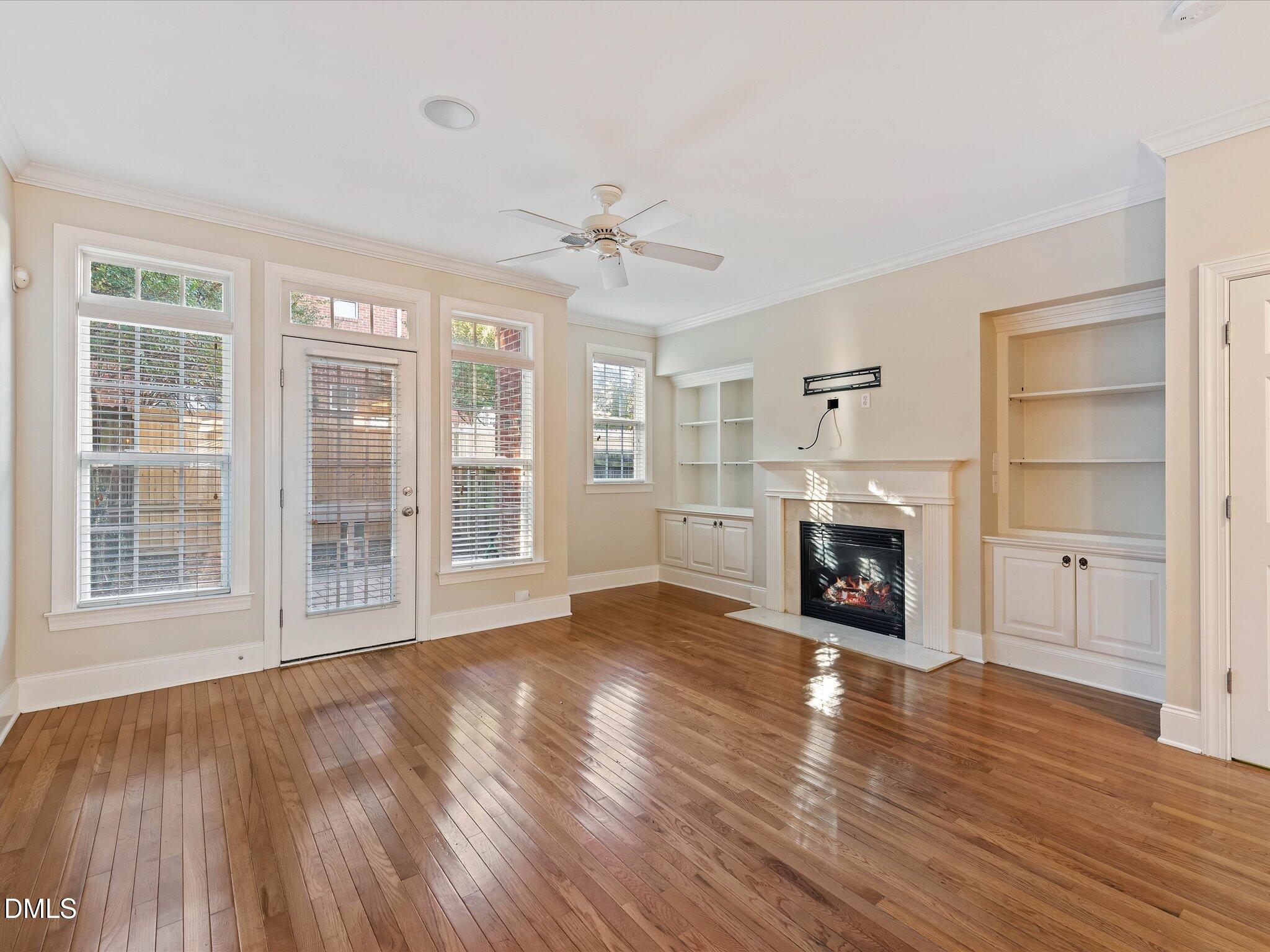 606 Highpark Lane Raleigh, NC 27608 - Photo 10 of 27 a view of an empty room with a fireplace and a window