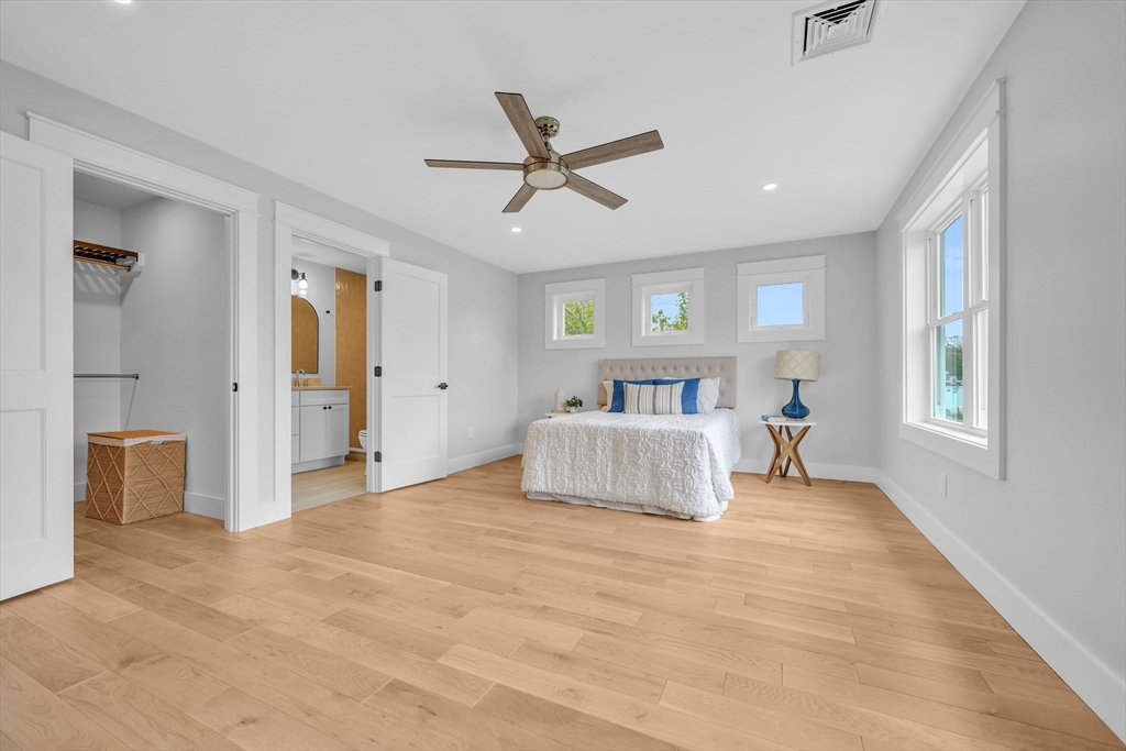 14 Hayes Street, Unit 1 Acushnet, MA 02743 - Photo 17 of 26 a bedroom with a large bed and a chandelier