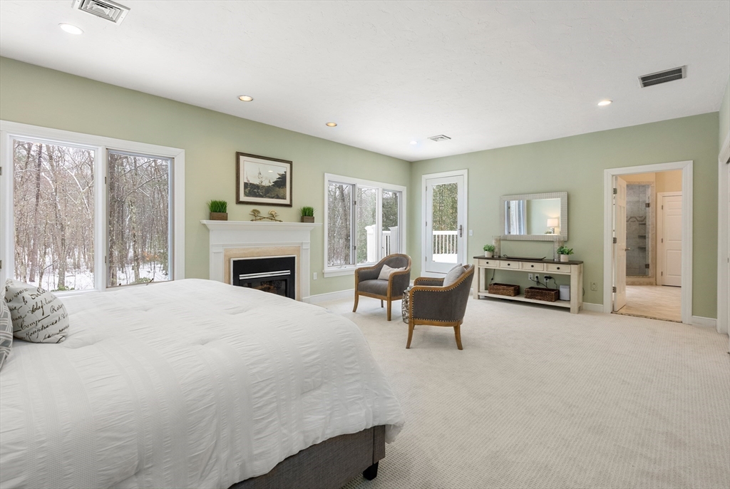 84 Phillips Road Sudbury, MA 01776 - Photo 16 of 34 a bedroom with furniture and a fireplace