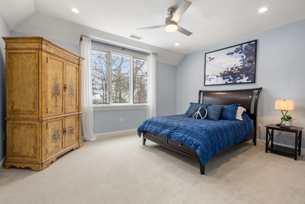 84 Phillips Road Sudbury, MA 01776 - Photo 21 of 34 a spacious bedroom with a large bed and a window