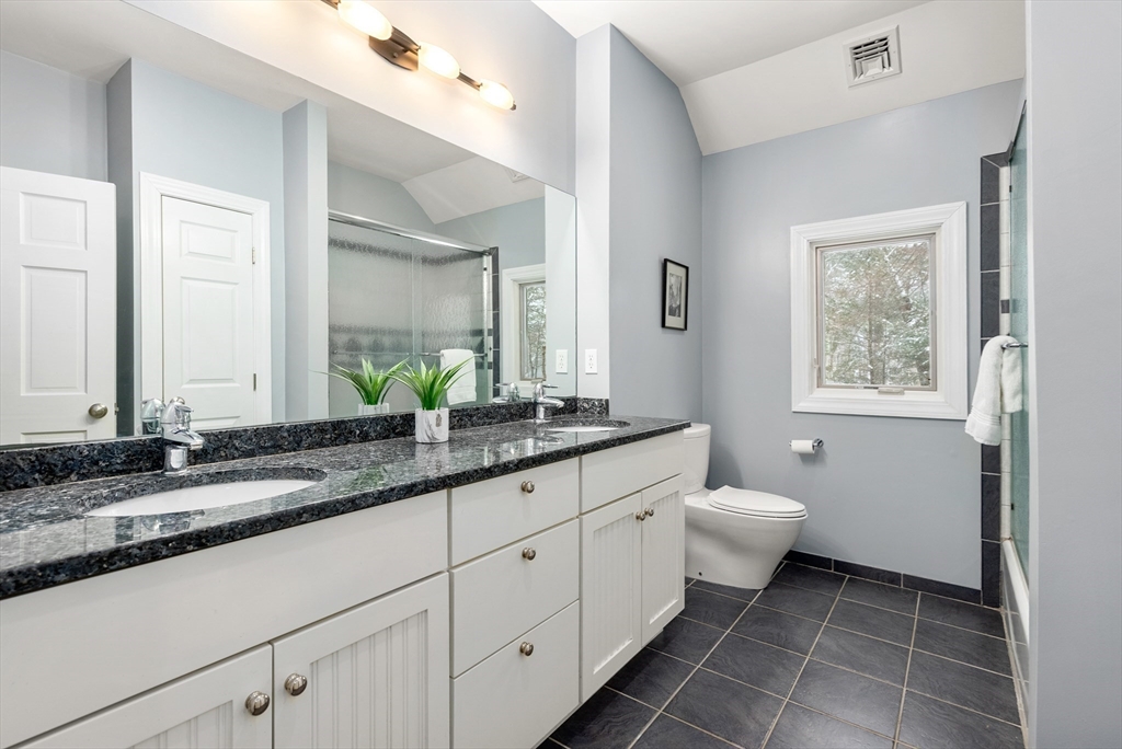 84 Phillips Road Sudbury, MA 01776 - Photo 23 of 34 a bathroom with a granite countertop sink toilet and mirror