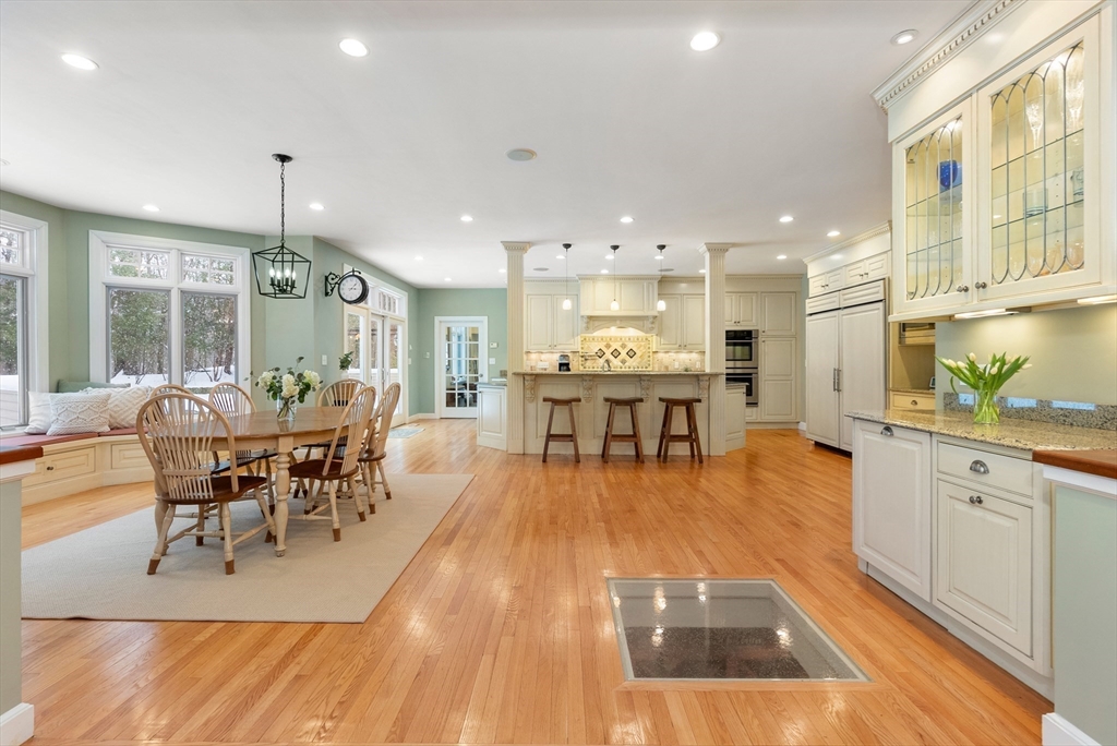 84 Phillips Road Sudbury, MA 01776 - Photo 5 of 34 an open kitchen with dining table and chairs