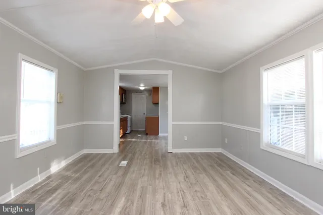 a large kitchen with wooden floors and stainless steel appliances