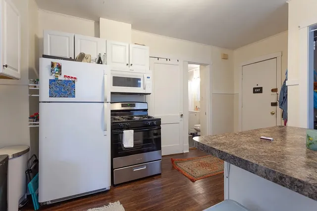 a kitchen with stainless steel appliances granite countertop a refrigerator and a stove
