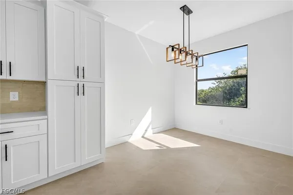 a view of a room with a chandelier fan