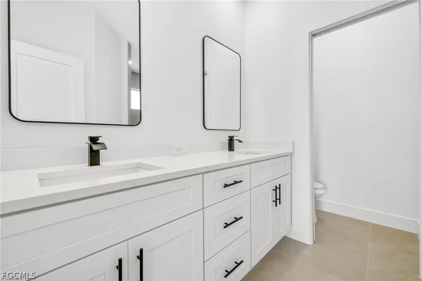 a bathroom with a double vanity sink mirror and