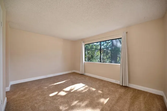 a view of a big room with closet and windows