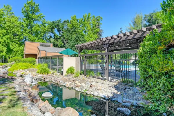 a view of a house with a yard and sitting area