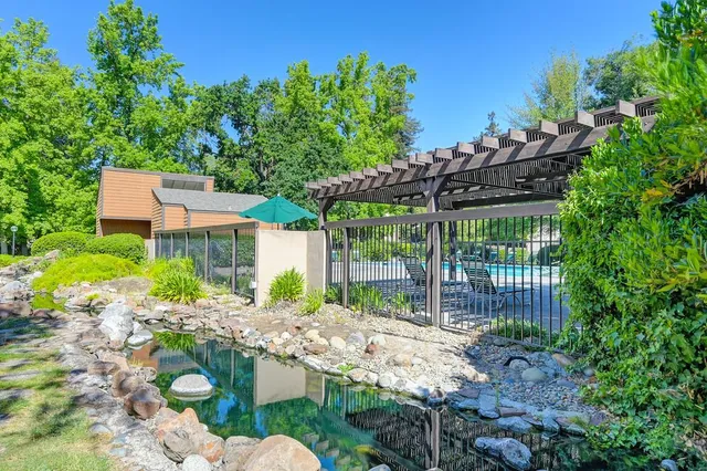 a view of a house with a yard and sitting area