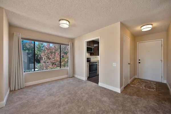 a kitchen with granite countertop wooden cabinets a stove and a sink